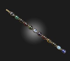A gemstone and diamond bracelet, set with twelve cabochons of various stones including moonstone,