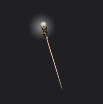 A late 19th century stickpin, designed as a coiled snaked beneath an untested pearl, the serpent