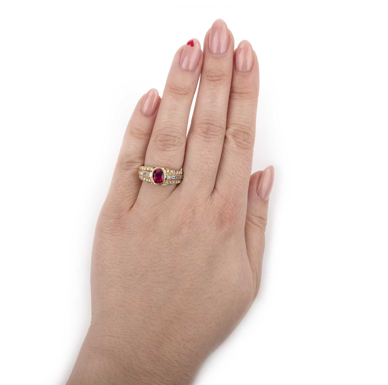 A ruby and diamond ring, set with an oval ruby within diamond-set shoulders in yellow gold, size M - Image 2 of 2