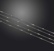 A platinum long guard chain, the small oval links set with seed pearls and separated with foliate