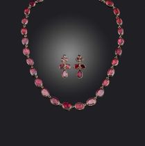 A garnet demi-parure, 19th century and later, comprising: a rivière necklace composed of flat oval
