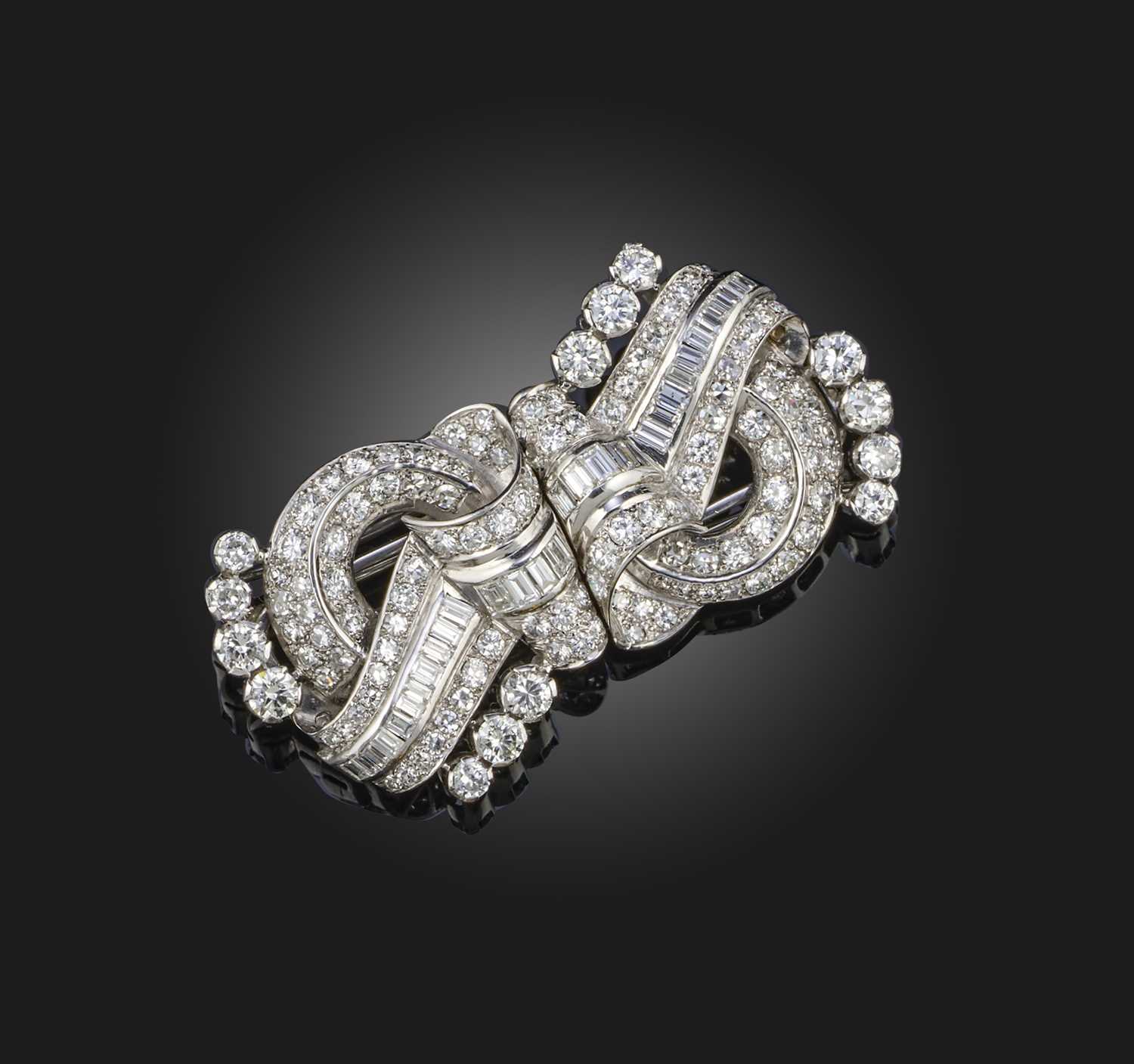 A diamond double clip brooch, mid 20th century, of scrolled design, set with circular-cut, single-