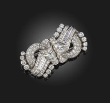 A diamond double clip brooch, mid 20th century, of scrolled design, set with circular-cut, single-