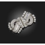 A diamond double clip brooch, mid 20th century, of scrolled design, set with circular-cut, single-