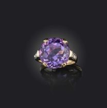 An amethyst and diamond ring, claw-set with a circular-cut amethyst, to shoulders set with