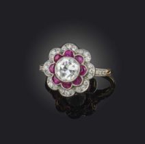A diamond and ruby ring, early 20th century, of cluster design, set with a circular-cut diamond