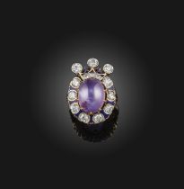 A star sapphire, enamel and diamond ring, claw-set with a cabochon oval star sapphire of violet tint