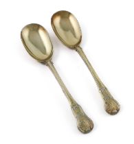 A pair of George III silver-gilt King's Hour Glass pattern serving spoons, by William Eley & William