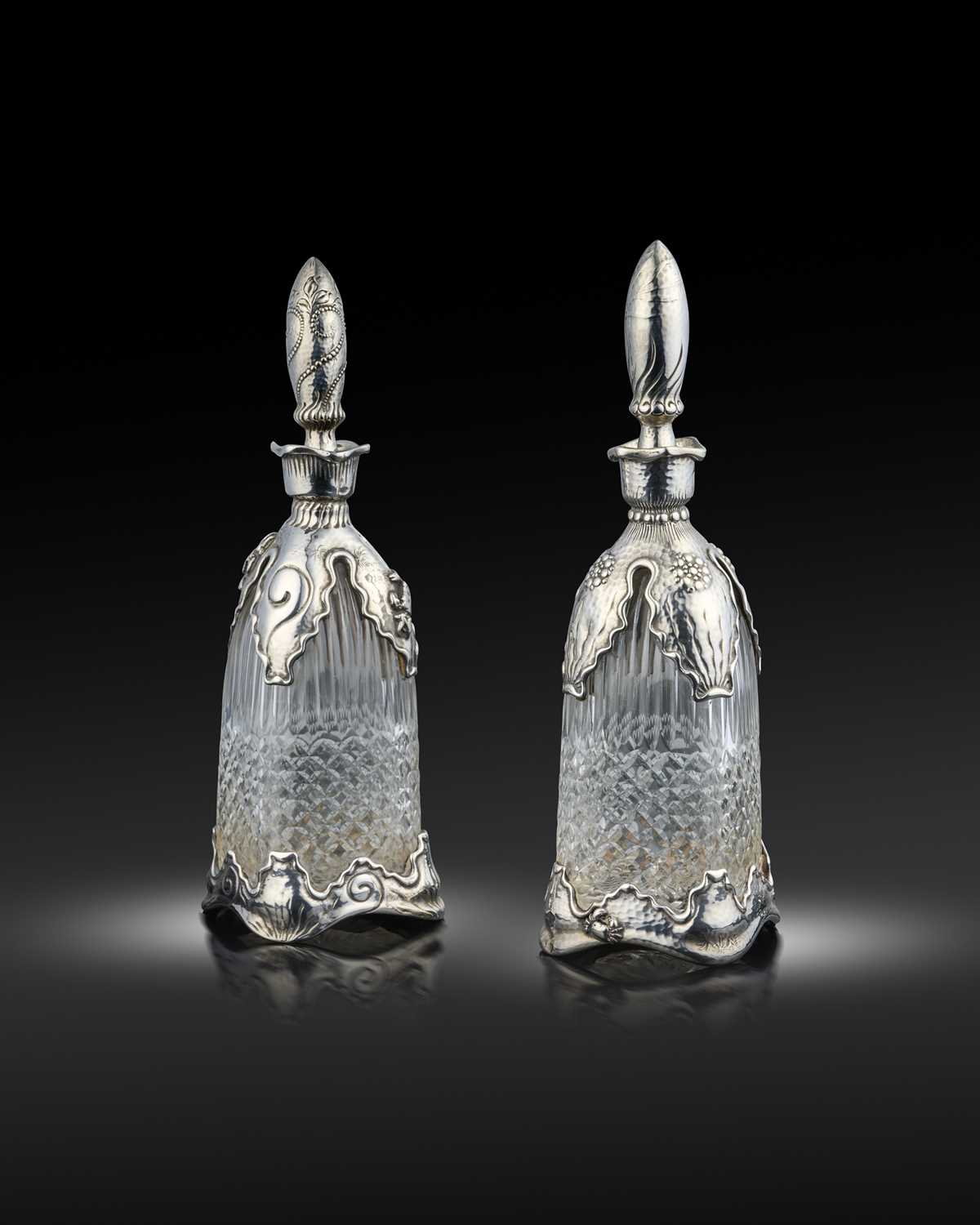 By Tiffany & Co., a similar pair of late-19th century American silver-mounted glass decanters,