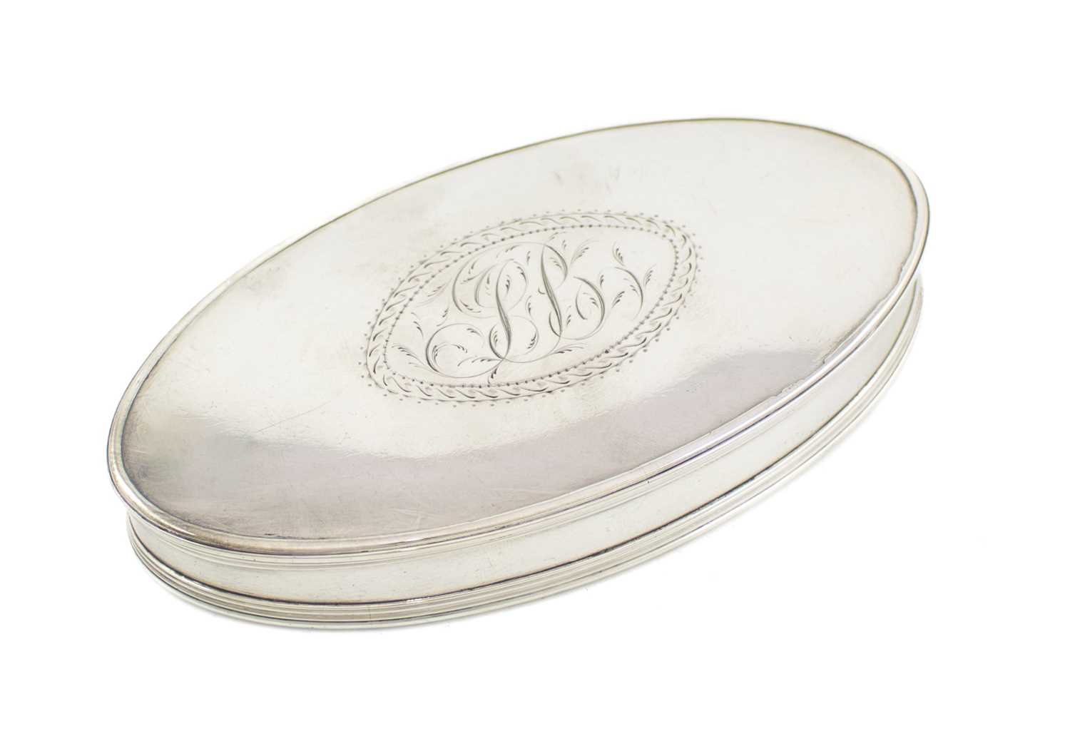 A George III silver snuff box, maker's mark worn, circa 1800, oval form, the pull-off cover with