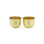 A matched pair of George II silver-gilt tumbler cups, marks worn, one London 1752, circular form,