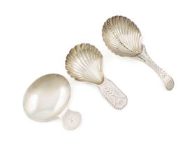 A small collection of three George III silver caddy spoons, comprising: one by William Brockwell,