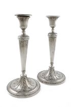 A pair of George III silver candlesticks, by Daniel Smith & Robert Sharp, London 1804, tapering
