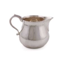 A Britannia standard silver cream jug, maker's mark WE, London 1924, baluster form, scroll handle,