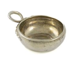 A 19th century French silver wine taster, plain circular form, double snake ring handle,
