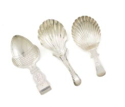 A small collection of three George III silver caddy spoons, comprising: one by Elizabeth Morley,