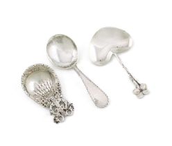Three American silver caddy spoons, including: one by Tiffany, with a heart-shaped bowl and flower