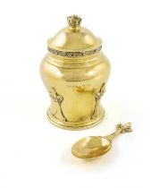 A silver-gilt tea caddy and spoon, by Goldsmiths & Silversmiths Co Ltd, London 1936, baluster