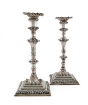 A pair of George III silver candlesticks, by William Cafe, London 1765, tapering baluster columns,