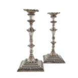 A pair of George III silver candlesticks, by William Cafe, London 1765, tapering baluster columns,