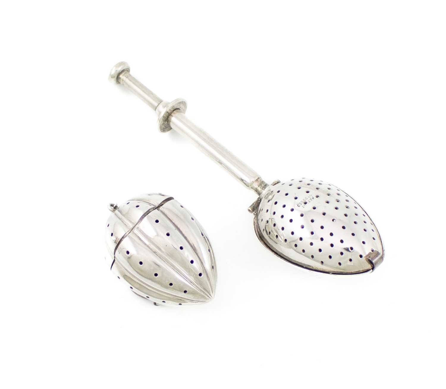 An American silver tea infuser, marked 'sterling', in the form of a fluted gourd, hinged cover