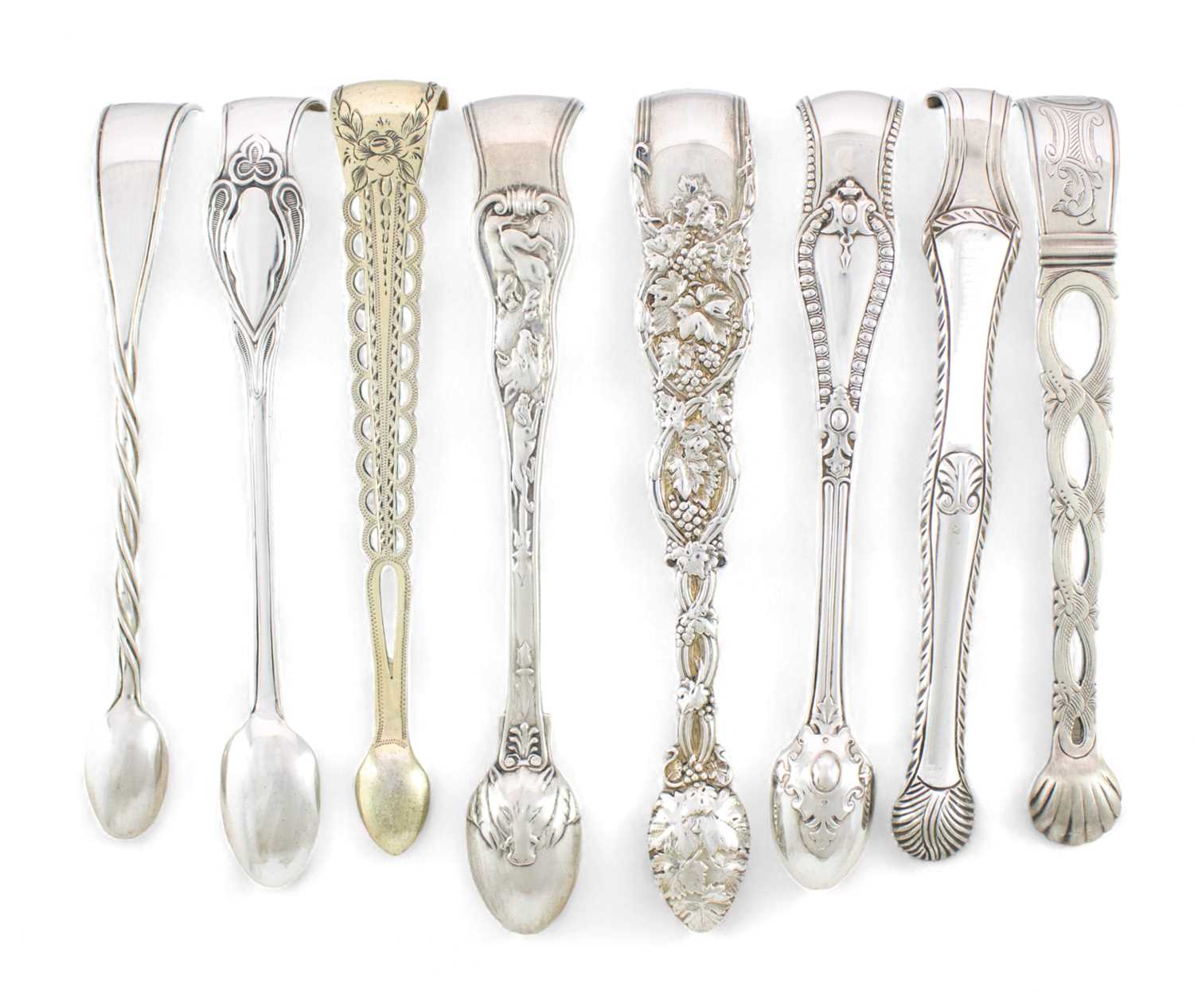 A collection of eight pairs of antique silver sugar tongs, including a Victorian Boar Hunt pattern