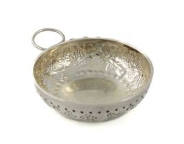 A 19th century French silver wine taster, unmarked, circular shape, chased foliate decoration,