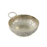 A 19th century French silver wine taster, unmarked, circular shape, chased foliate decoration,