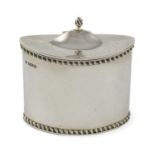 A small silver tea caddy, by Haseler Brothers, Chester 1913, oval form, gadroon border, a domed