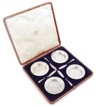 A cased set of four silver butter dishes and knives, by The Goldsmiths and Silversmiths Company,