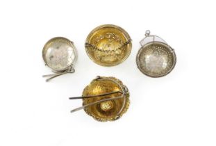 A small collection of antique silver tea strainers: comprising: a William IV strainer by Charles