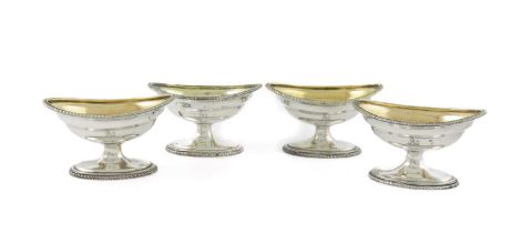 A set of four George III salt cellars, by John Gold, London 1802, oval form, gadrooned border, on