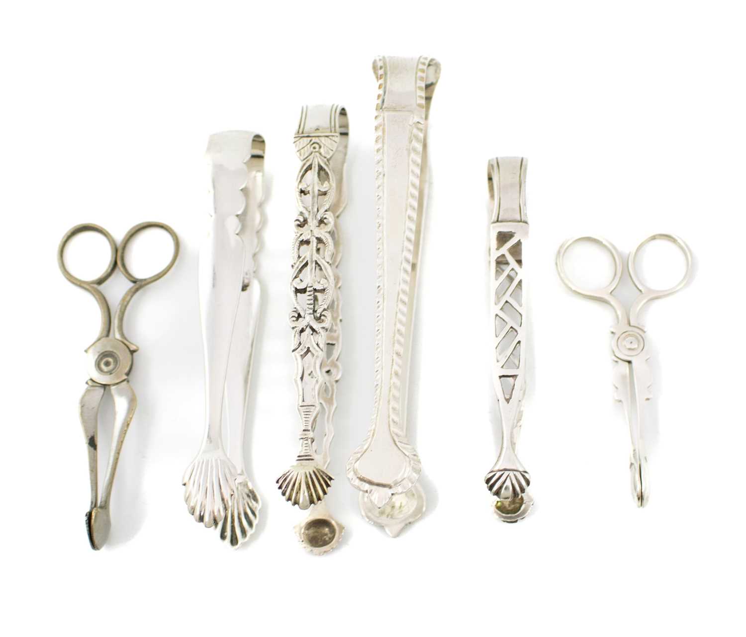 A collection of small and miniature silver sugar tongs, including a George III pair with pierced