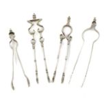 A collection of four pairs of early-18th century silver sugar tongs, comprising: an andiron pair,