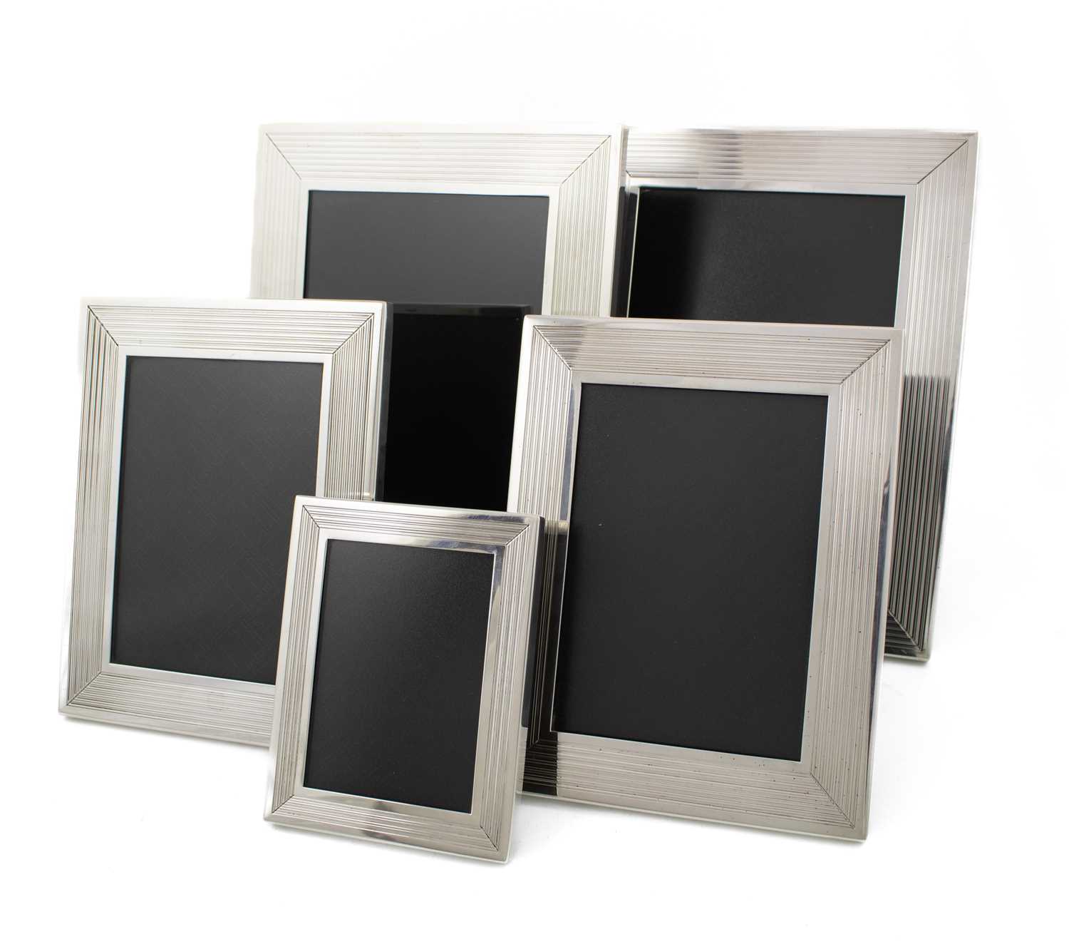 By Dunhill, a set of five modern silver photograph frames, maker's mark of Alfred Dunhill and