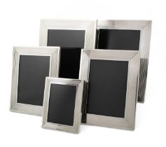 By Dunhill, a set of five modern silver photograph frames, maker's mark of Alfred Dunhill and