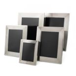 By Dunhill, a set of five modern silver photograph frames, maker's mark of Alfred Dunhill and