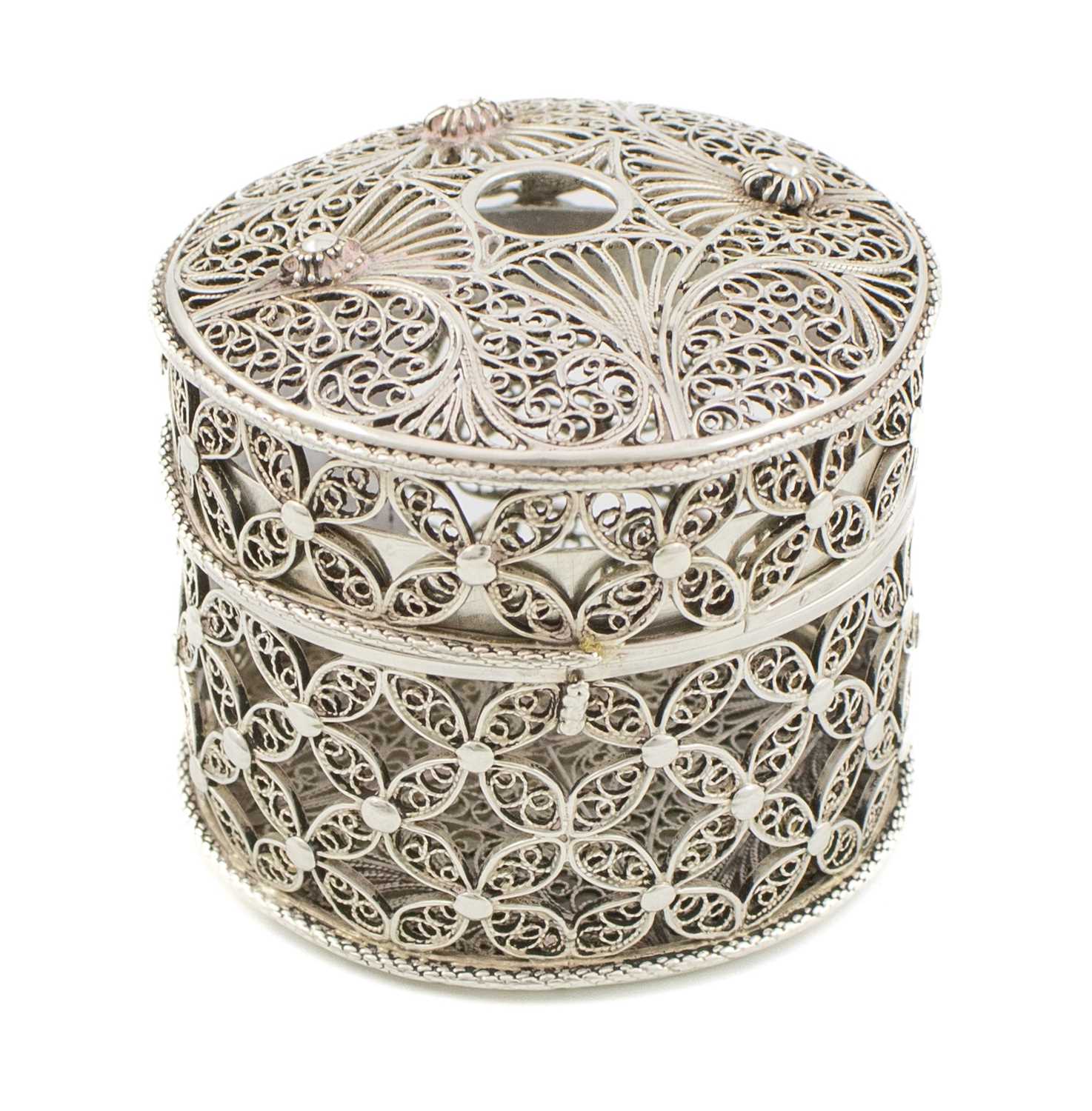A silver filigree bougie box, unmarked, probably 19th century, cylindrical form, pull-off cover with