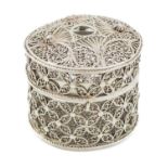 A silver filigree bougie box, unmarked, probably 19th century, cylindrical form, pull-off cover with