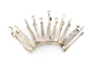 A collection of antique silver sugar tongs, various dates and makers, comprising: three cast