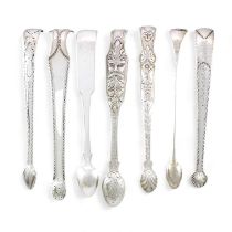 A collection of seven pairs of George III- Victorian Irish silver sugar tongs, comprising: a