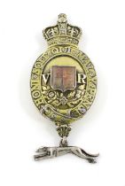 A Victorian silver-gilt Queen's messenger's badge, unmarked, shaped oval form surmounted with a