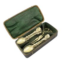 A set of ten 18th century silver-gilt naturalistic teaspoons and sugar nips, unmarked, scroll