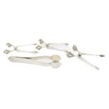 By Georg Jensen, a collection of three pairs of Danish silver sugar tongs, comprising: a pair of