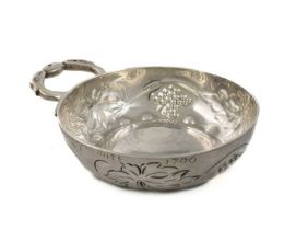 A late-18th century French silver wine taster, maker's mark possibly MP, circular form, vine and