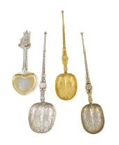 A mixed lot of silver spoons, comprising: two Edwardian silver-gilt anointing spoons by Cornelius