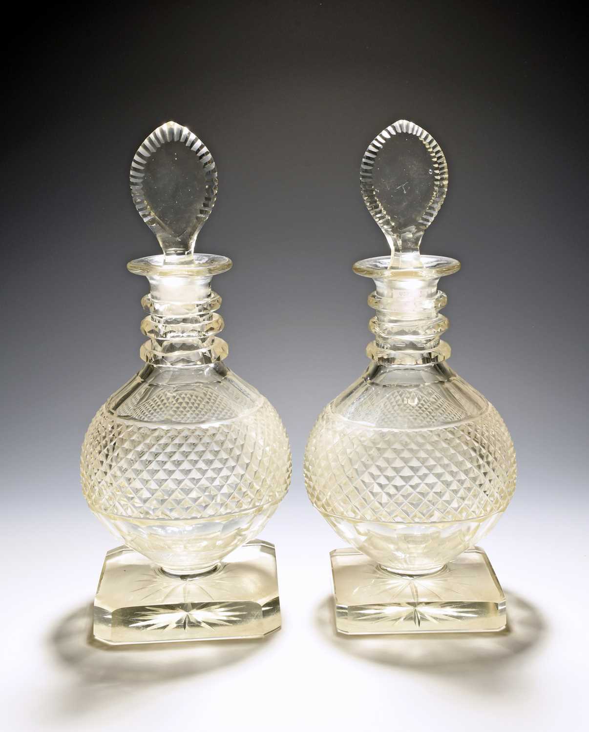 An unusual pair of Irish cut glass decanters and stoppers, 19th/early 20th century, the rounded