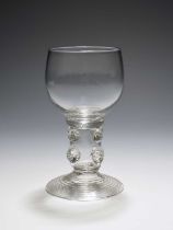 An English glass roemer for the export market, 18th century, the cup bowl raised on a thick hollow