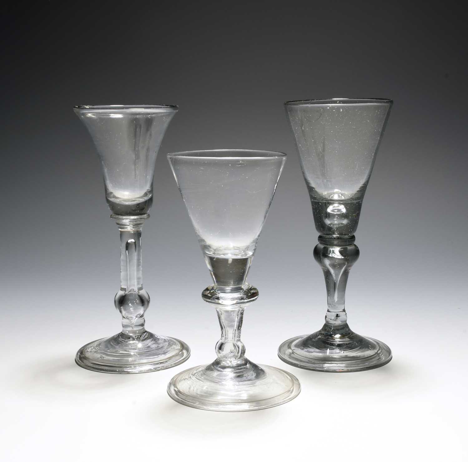 Two English balustroid wine glasses, c.1740, one with a bell bowl, the other with a funnel bowl,