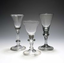 Two English balustroid wine glasses, c.1740, one with a bell bowl, the other with a funnel bowl,